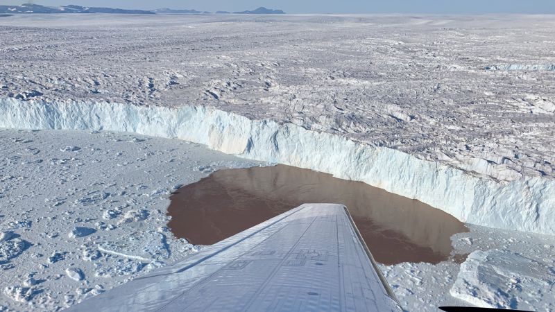 An image taken during an air campaign for the OMG mission in Greenland, shows the edge of a glacier surrounded by a layer of ice, pieces of which have broken off during calving events.