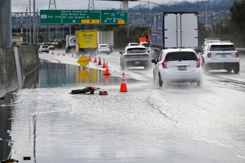 In this Dec. 20, 2023, file photo, the left lane is closed as cars commute on Highway 101 near the San Francisco International Airport (SFO) as heavy rain hits San Francisco.